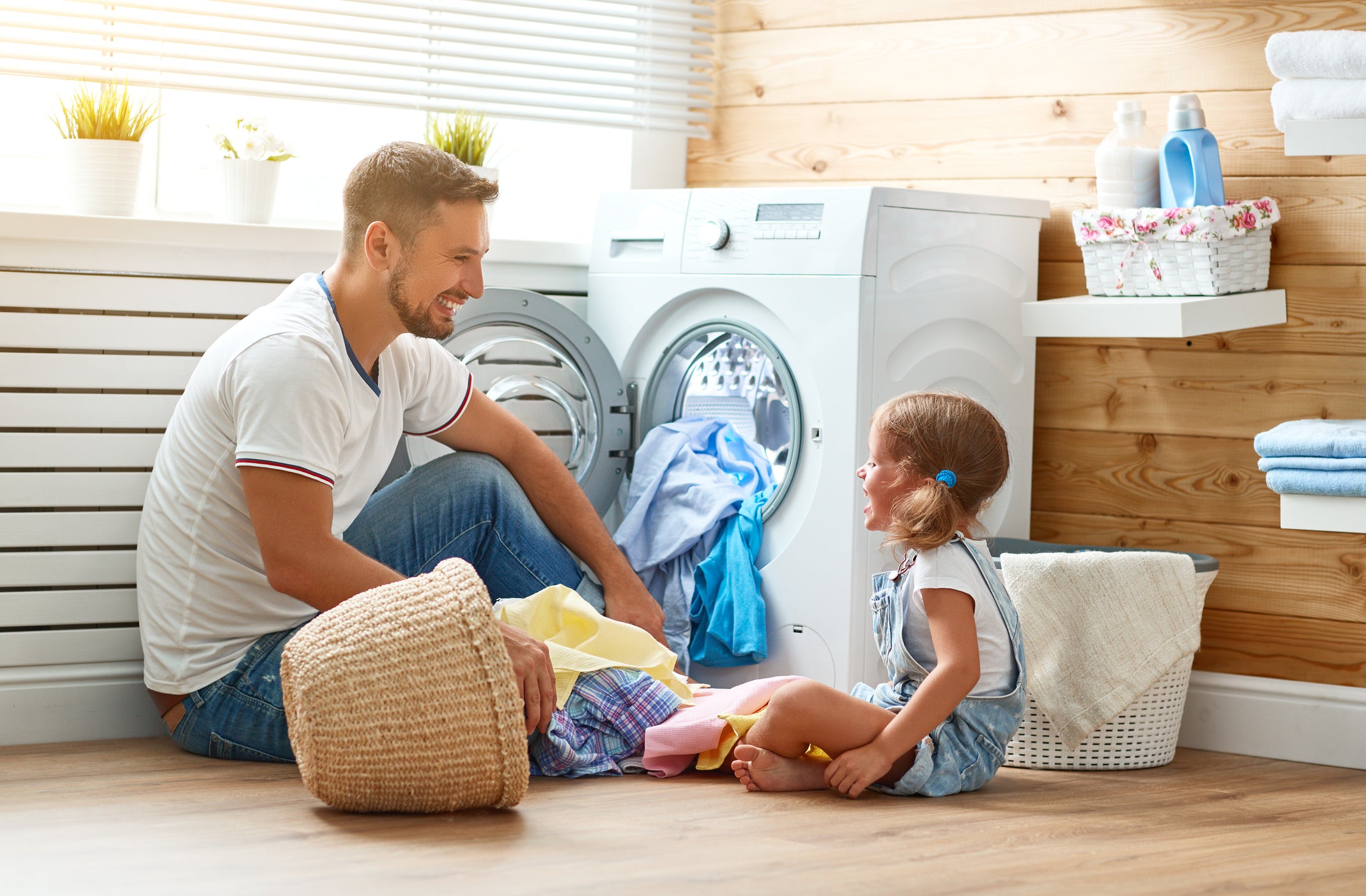 Image of dad and daughter doing laundry